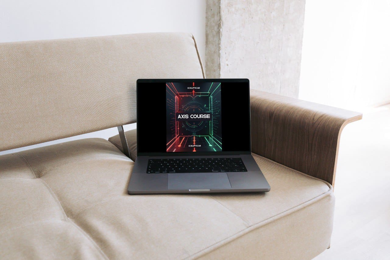 Laptop on a beige couch with a digital course 'Axis Course' interface displayed on the screen.