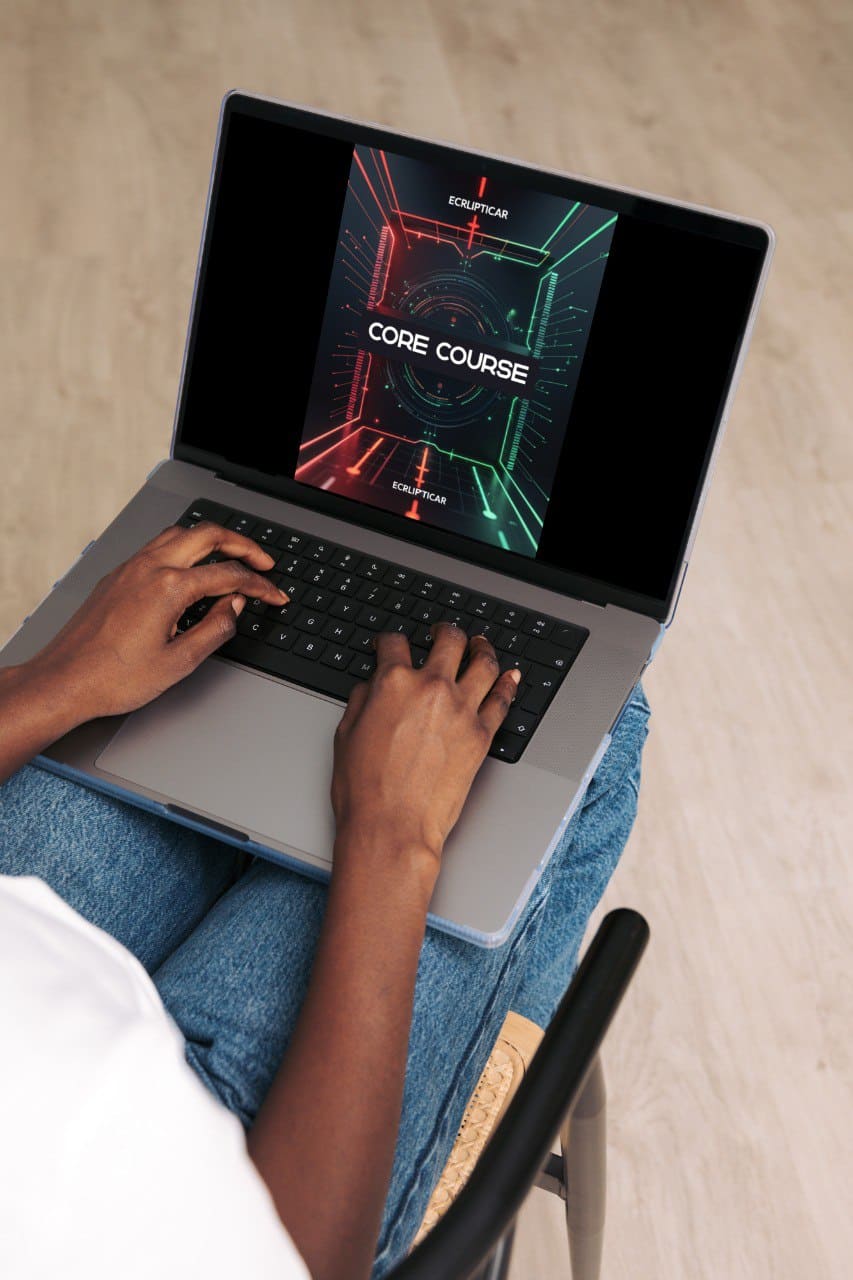 Person using a laptop with a 'Core Course' screen on a beige surface