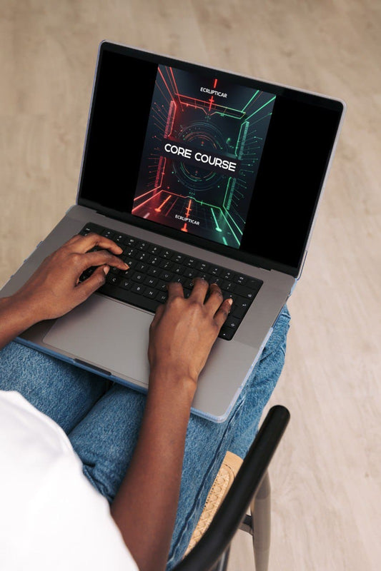 Person using a laptop with a 'Core Course' screen on a beige surface
